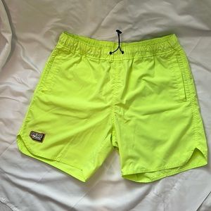 Men’s neon yellow shorts.